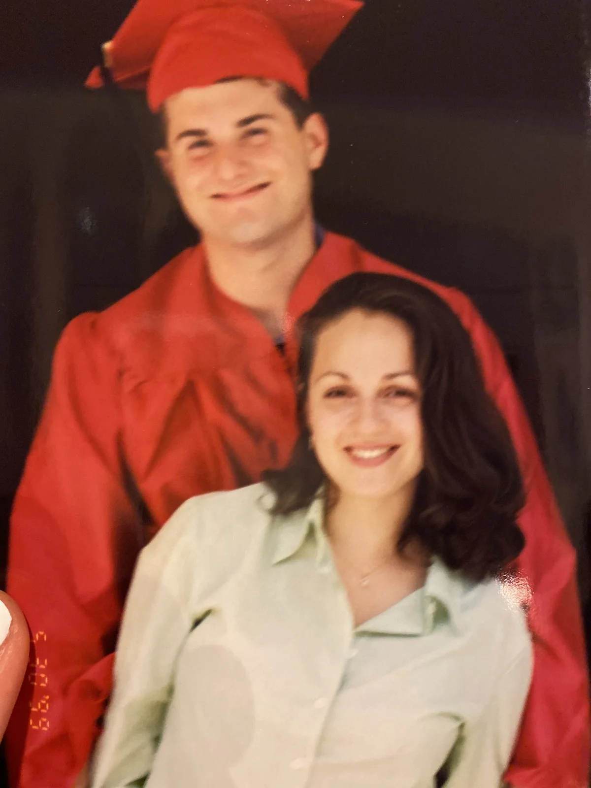 Avi in a red Wesleyan graduation cap and gown with Nataly, 1999